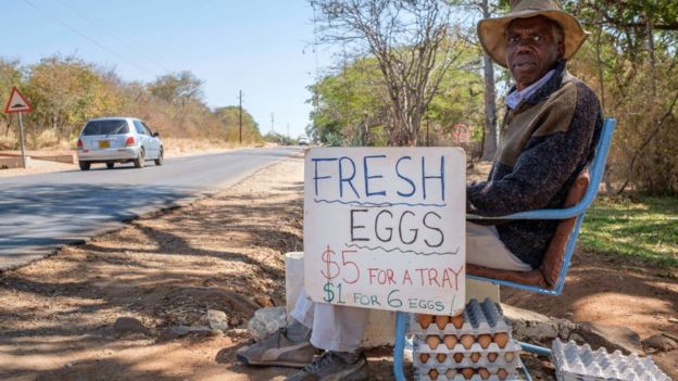 Man selling eggs by the side of the road in Zimbabwe in 2016