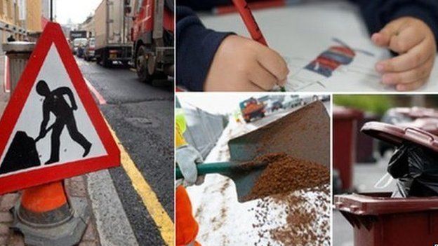 Traffic sign, child writing, road being dug up, and bins waiting to be emptied