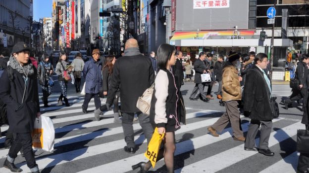 People walk across the street in Japan