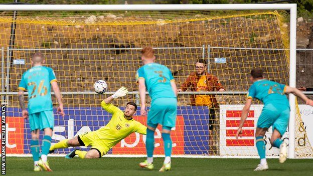 Sutton midfielder Robert Milsom's penalty beat Newport goalkeeper Joe Day