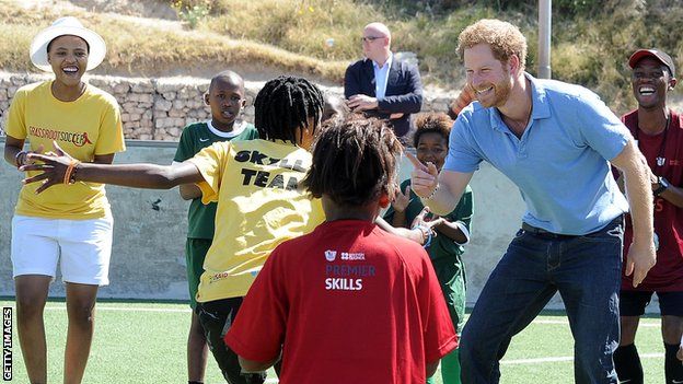 Prince Harry plays with a group of children at the Khayelitsha Football for Hope Centre in 2015