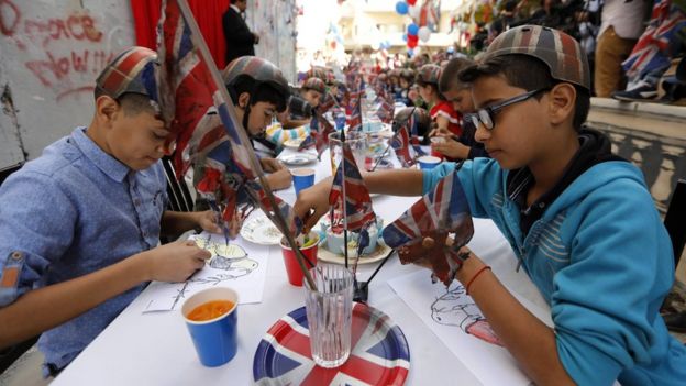 Palestinian children at a long table festooned with the British flag (1 November 2017)
