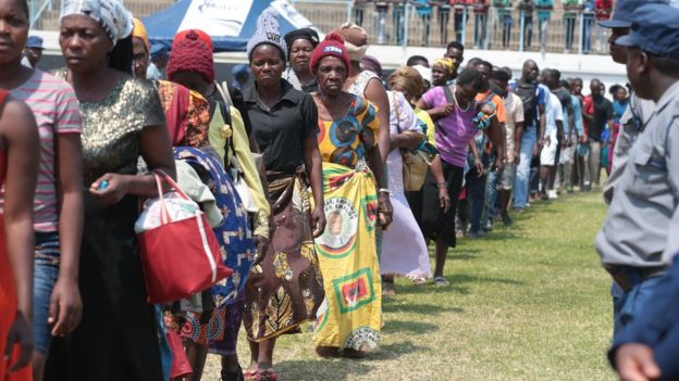 Members of the public queue to view Robert Mugabe's body as it lies in state in Harare