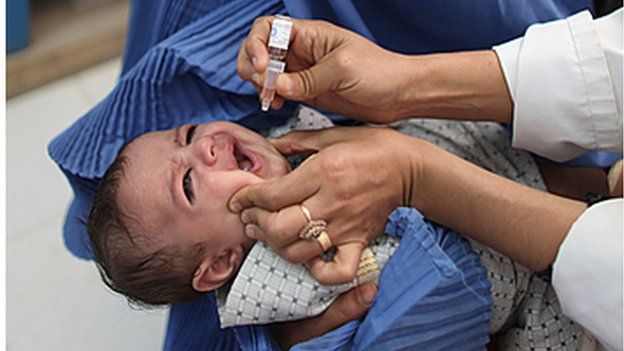 A child is given vaccine in an Afghanistan hospital