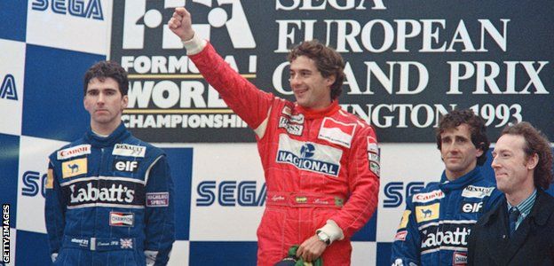 Ayrton Senna celebrates on the podium after winning the 1993 European Grand Prix at Donington Park, flanked by Damon Hill and Alain Prost