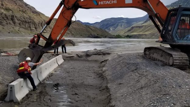 Workers create a tank for the fish