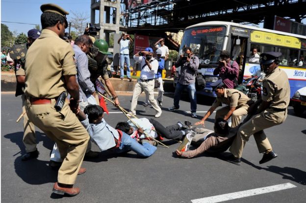 Police try to detain students protesting against the California-based Tri-Valley University outside the US consulate in Hyderabad city in 2011.