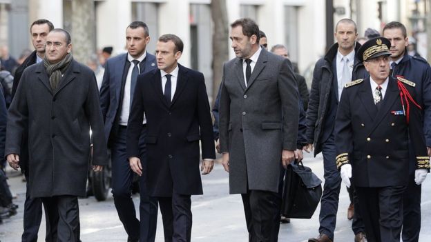 President Macron with Interior Minister Christophe Castaner and Paris police prefect Michel Delpuech (R) walk the streets of Paris in the aftermath of riots