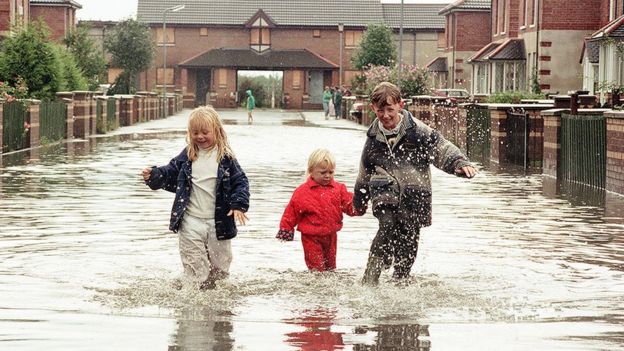 Children splashing in flood water