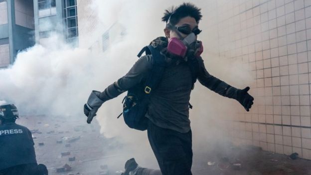 Protesters run on a street during an attempt to leave Polytechnic University