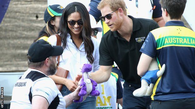 Prince Harry and Meghan Markle greated by 2017 Invictus Games participants during a wheelchair tennis match at Nathan Philips Square in Toronto