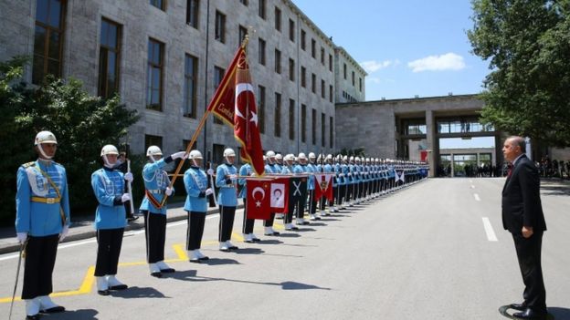 President Erdogan inspects the honour guard as he arrives for a special session of parliament in Ankara