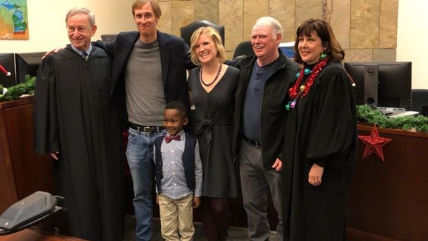 A picture shared by Kent County, Michigan's Facebook page shows a little boy named Michael being formally adopted in court