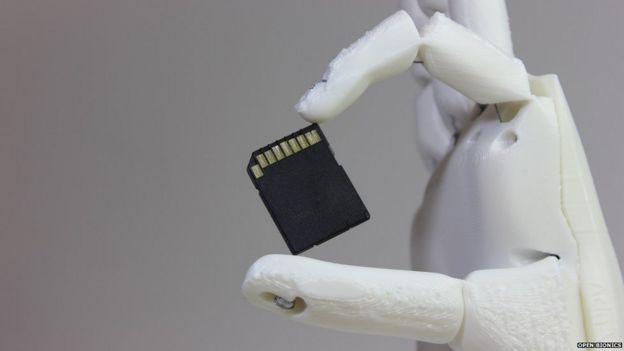 Ada holding a memory card