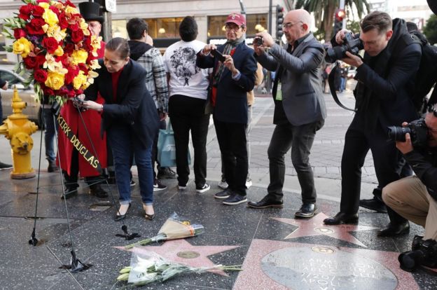 A floral tribute being erected at Douglas's star on the Hollywood Walk of Fame