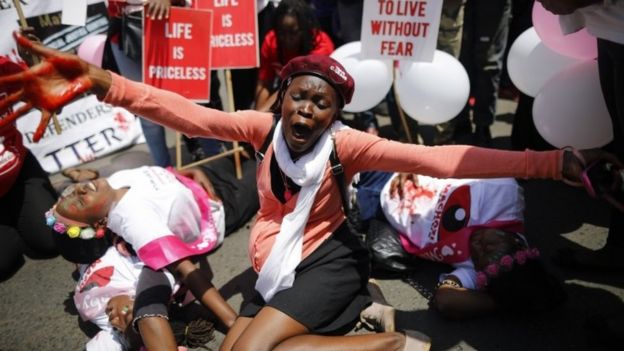 Kenyan activists, with balloons in their shirts to represent the murdered university student Sharon Otieno, who was seven-month pregnant at the time of her death, re-enact her murder during a protest to demand justice for her in Nairobi, Kenya, 14 September 2018