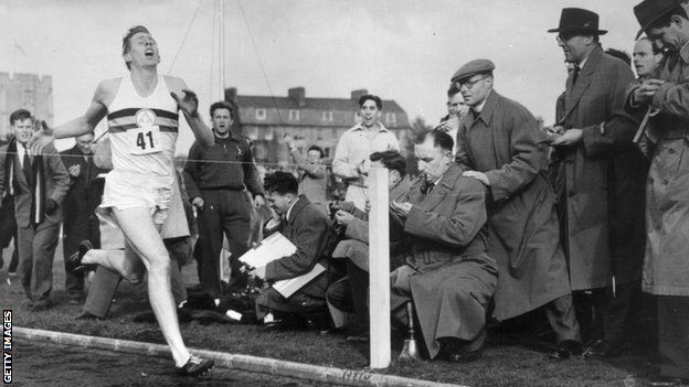 Roger Bannister crosses the finishing line as he runs the first sub-four-minute mile