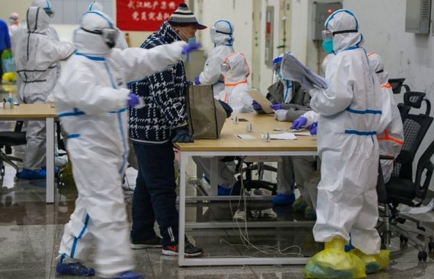 Medical workers receive a patient at the Wuhan International Conference and Exhibition Centre