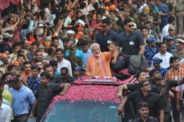Prime Minister Narendra Modi waves to public during road show at Assi Ghat road on April 25, 2019 in Varanasi, India.