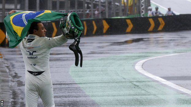 Massa walks down the pit lane