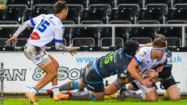 Castres' Bastien Guillemin is pushed into touch by the Ospreys defence