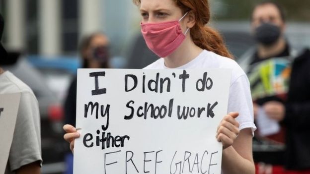Student holds up a sign saying: "I didn't do my schoolwork either. Free Grace"at a rally in the Detroit suburb of Pontiac on 16 July 2020