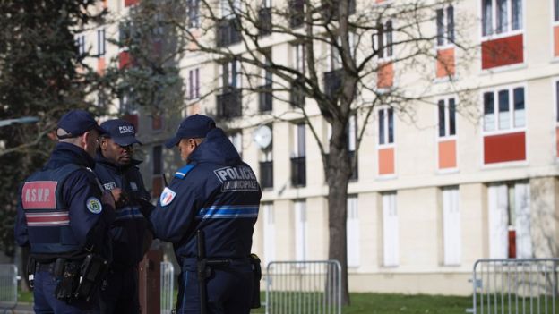 Municipal police officers stand guard near a building on 11 February 2016 in Sarcelles