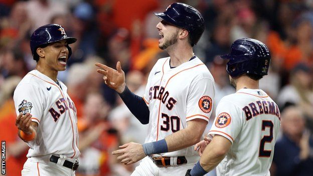 Houston Astros' Kyle Tycker (centre) celebrates a home run with Jeremy Pena and Alex Bregman