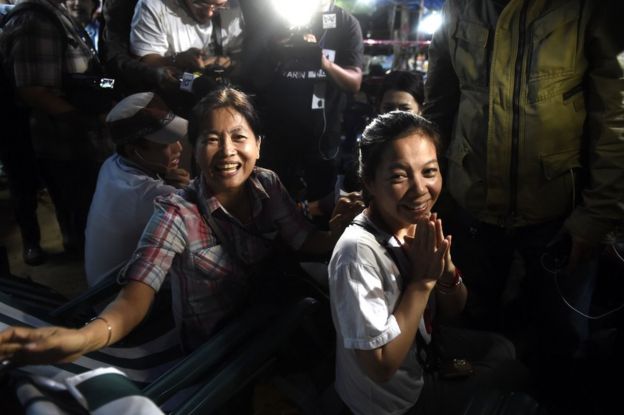Family members celebrate while camping out near Than Luang cave following news all members of children's football team and their coach were alive in the cave at Khun Nam Nang, 2 July
