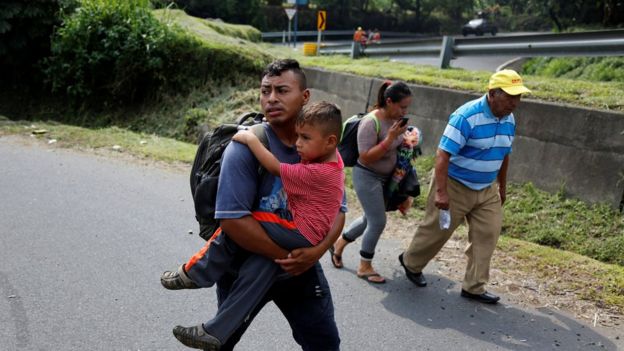 Displaced people walk along a road from an area affected by the eruption of Fuego volcano in Escuintla, Guatemala, 5 June 2018