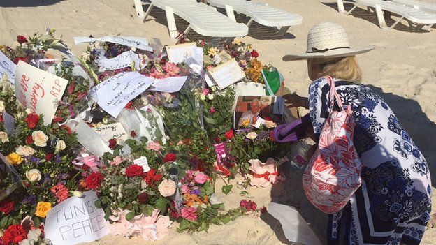 Holidaymaker leaving flowers at scene of attack