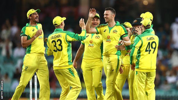 Australia celebrate after fast bowler Josh Hazlewood (centre) takes a wicket against India