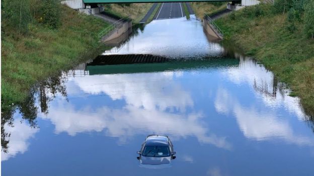 Strandard car on flooded relief road