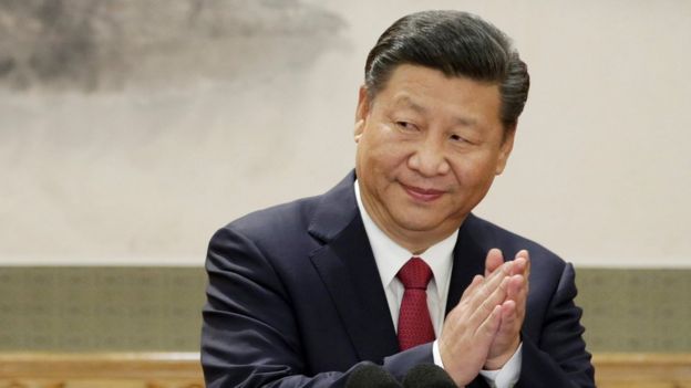Xi Jinping claps, looking slightly to the side of the frame