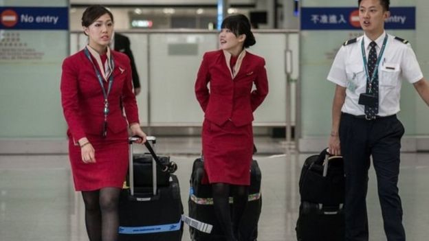 Female cabin crew at Cathay Pacific have won a battle to scrap a rule forcing them to wear skirts.The Hong Kong airline has agreed flight attendants can choose to wear trousers, after intense union pressure.