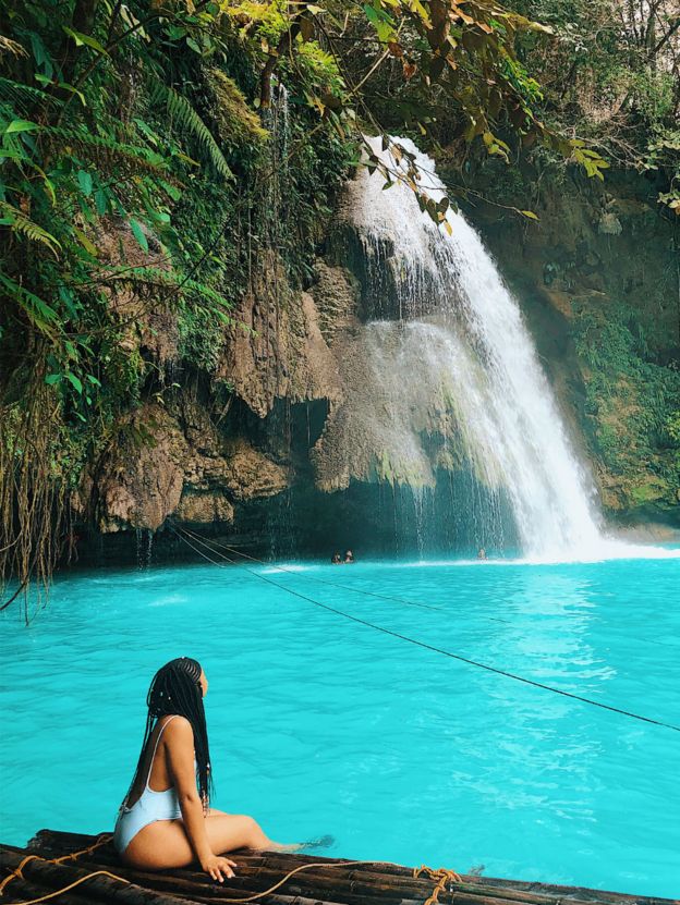Briona Lamback sits by a waterfall in Cebu, in the Philippines.