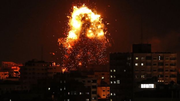 The building housing the Hamas-run television station Al-Aqsa in the Gaza Strip is hit during an Israeli air strike, 2 November 2018
