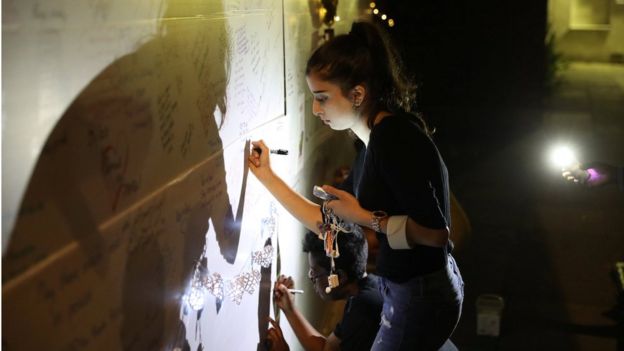 People have been signing a wall of condolence