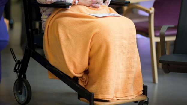 An elderly woman in wheelchair inside a hospital in Cardiff, UK