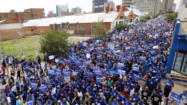 Demonstrators march through the city of Johannesburg as they call for the removal of South African President Jacob Zuma, 7 April 2017