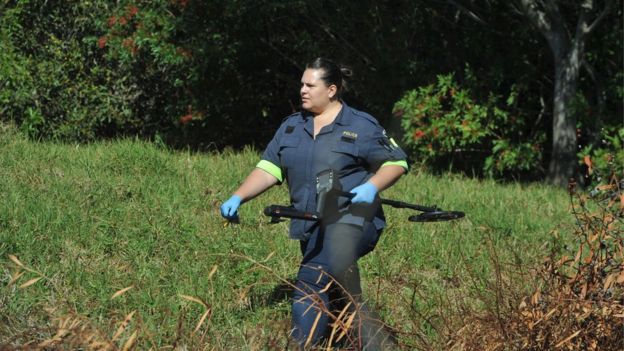 Police and forensic investigators at the crime scene where Mark Minnie was found dead on August 14, 2018 in Port Elizabeth, South Africa. Minnie, who co-authored, The Lost Boys of Bird Island book that implicates two powerful apartheid officials and a businessperson in an alleged paedophile ring, was found with a bullet wound to his head and a firearm was found near his body, on a farm in Port Elizabeth