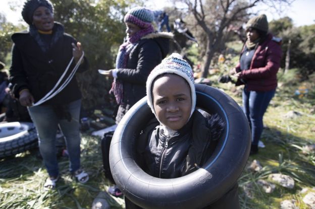 An African migrant boy plays with a rubber ring as they wait before attempting to cross the Aegean Sea by boat to reach the Greek island of Lesbos, in Ayvacik district, Canakkale region, Turkey, 3 March