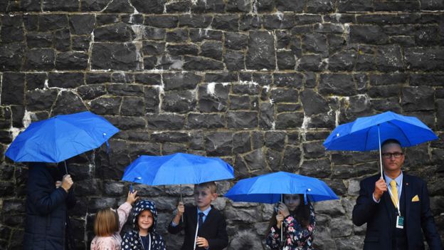 People waiting in the rain for Pope Francis in Knock