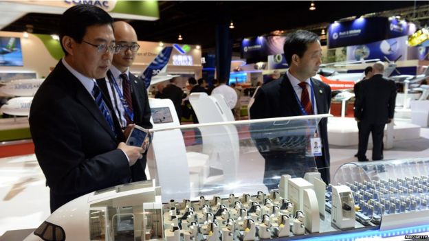 A guest looks at the cabin interior of the model display of an Airbus A350-XWB plane at the Singapore Airshow