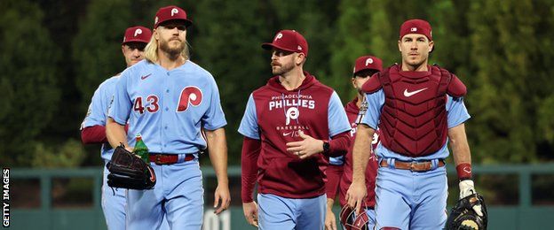 Pitcher Noah Syndergaard (left) and the Philadelphia Phillies players walk off the field