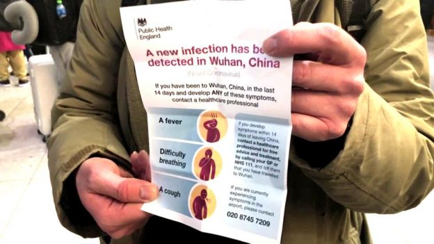 Passenger holding leaflet about the infection