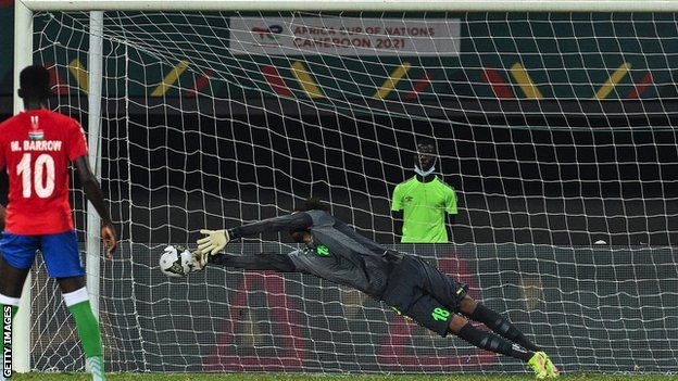 The Gambia goalkeeper Baboucarr Gaye stops a penalty kick