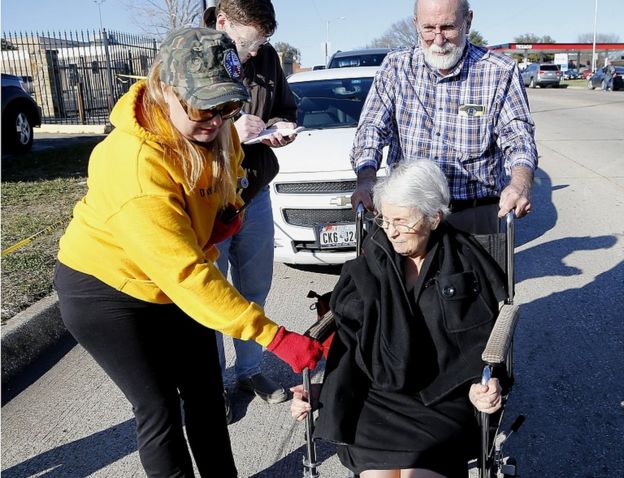 Dannetta Maldonado (left) helps Diana Richardson as she is pushed by her husband John Richardson after a shooting took place at West Freeway Church of Christ on December 29, 2019