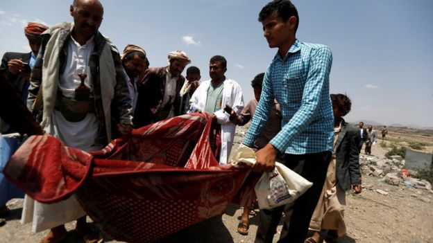 People carry the body of a man they recovered from the site of Saudi-led coalition air strike in Arhab area, north of Sanaa, Yemen (23 August 2017)