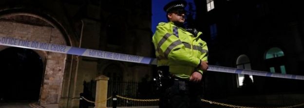 Police officers secure a police cordon near Forbury Gardens park in Reading, west of London